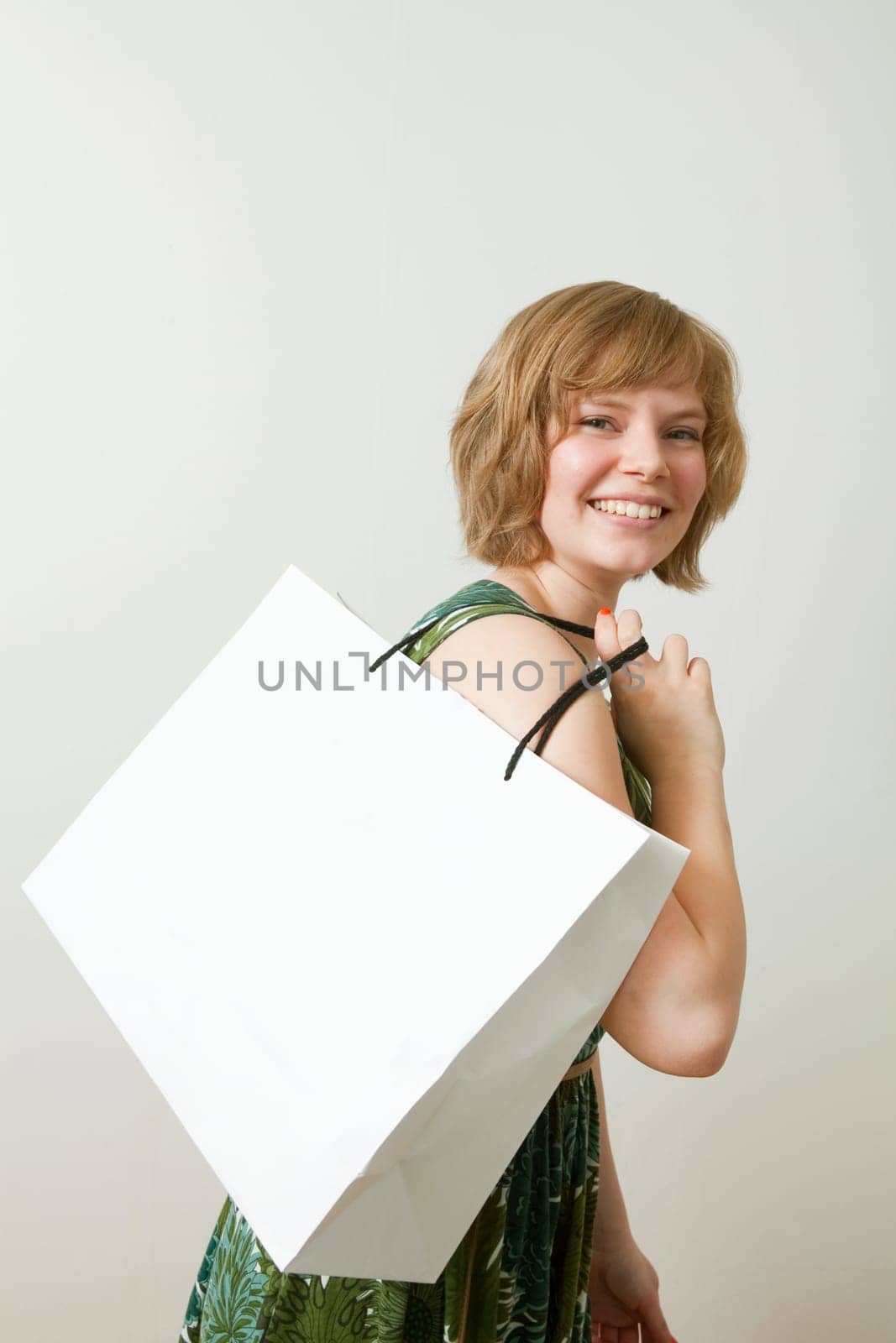 Young woman carrying a shopping bag on her shoulder