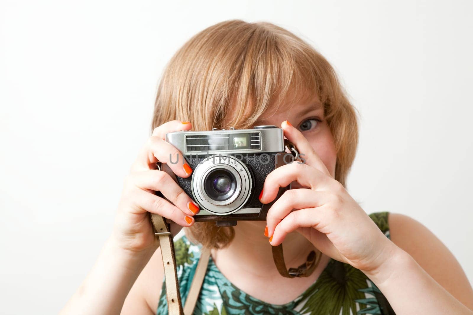 Young woman holding an old vintage camera
