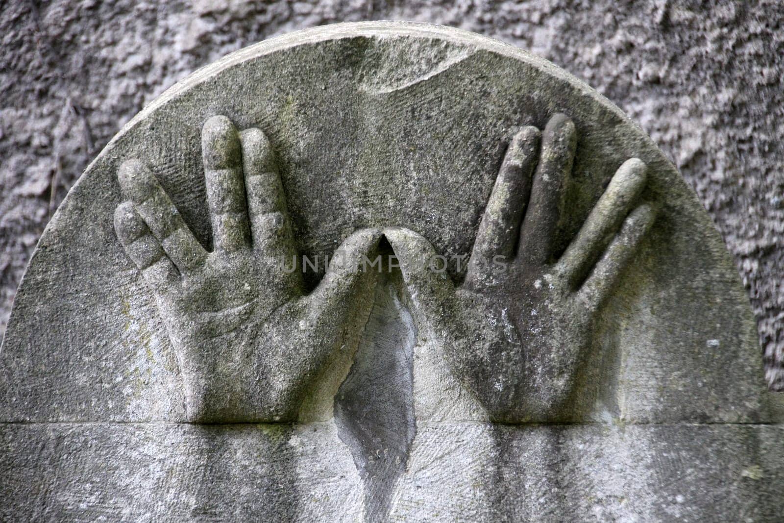 Hands on a Jewish gravestone