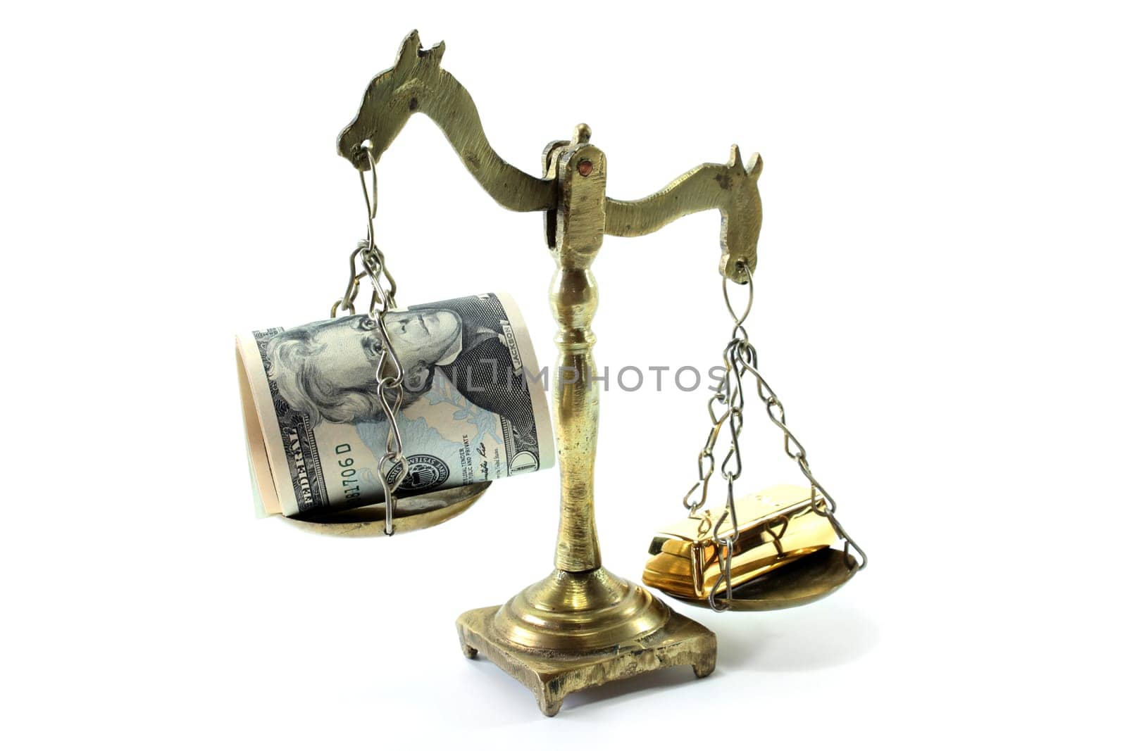 A bar scale with dollar bills and gold bars against a white background