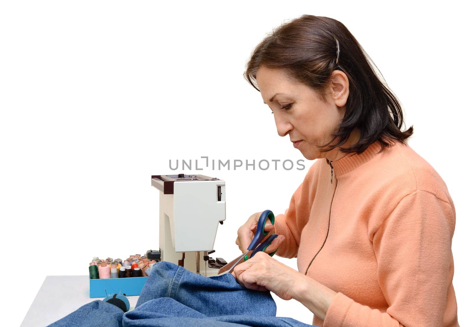 Experienced seamstress at work,studio shot,isolated on white
