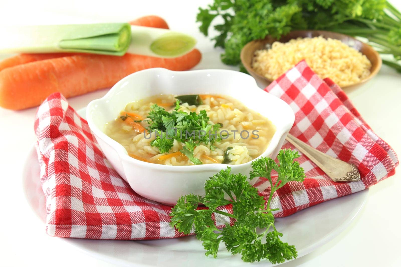 a bowl of noodle soup with parsley