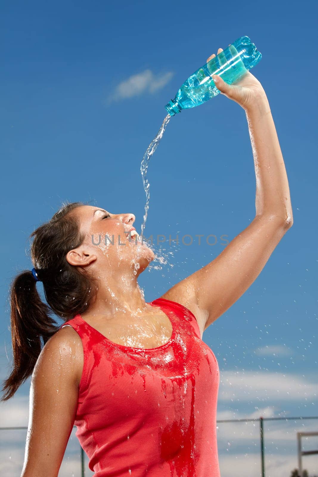 Young woman splashing herself with water