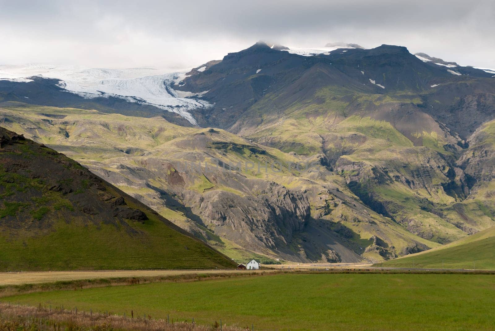 mountains between lights and shadows in vik in iceland