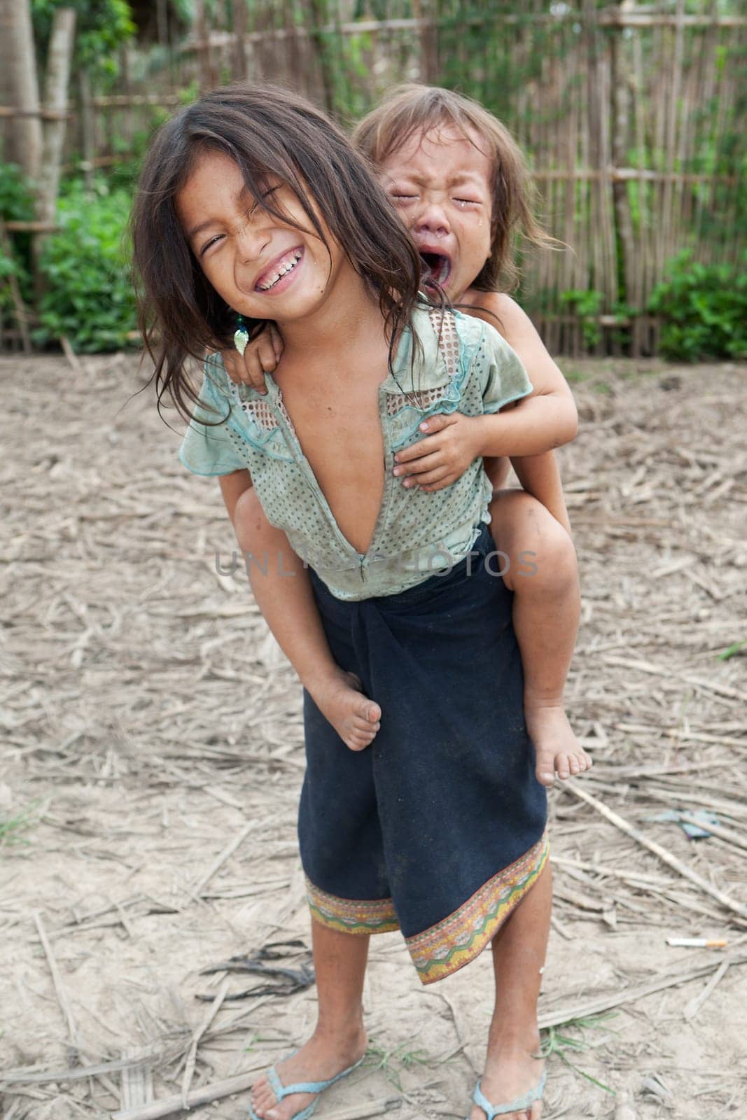 Children from Asia,especially in Laos,live with dirty clothes and no chance of education