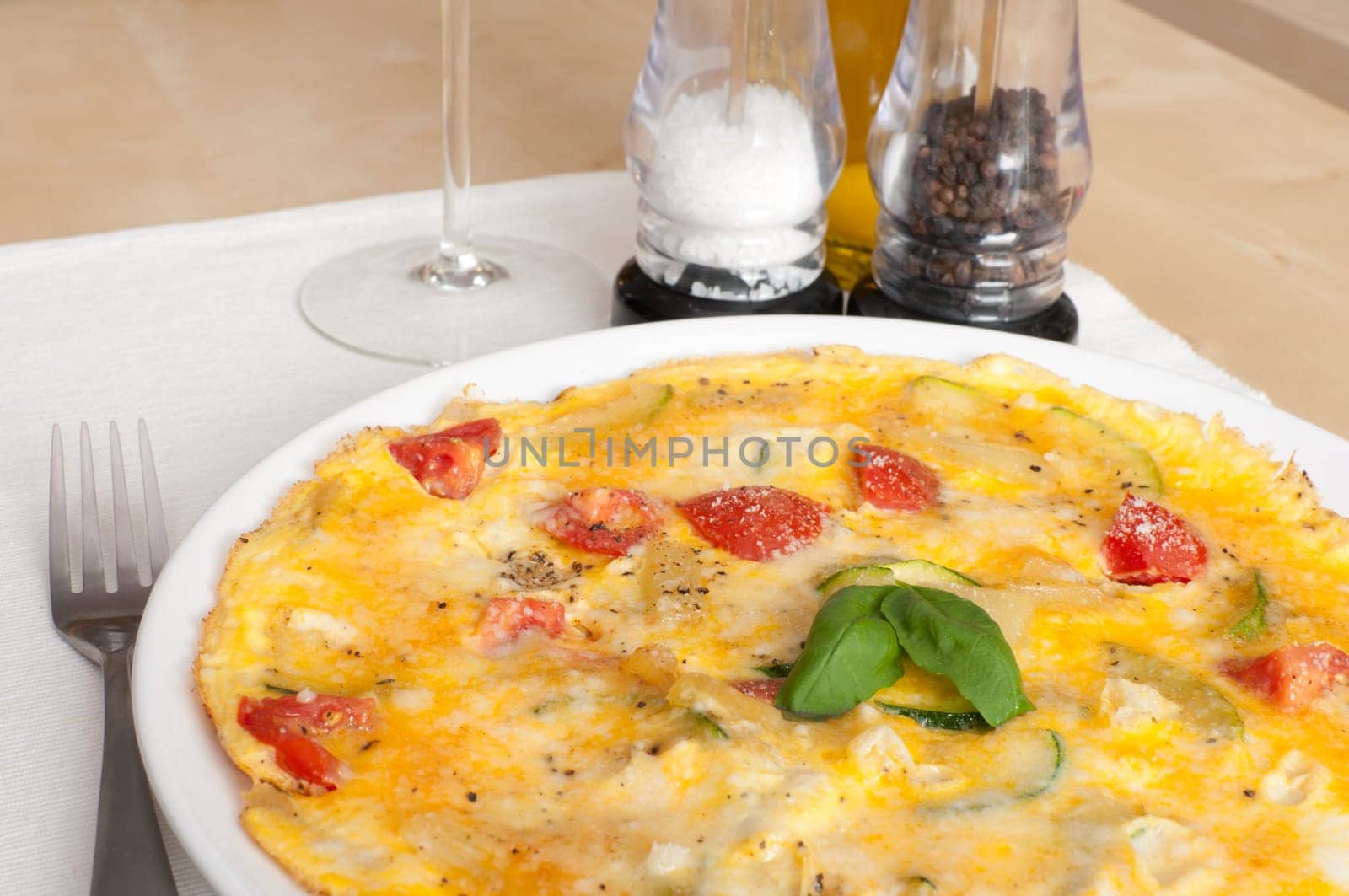 Egg Omelette With Tomatoes and Basil on the Table