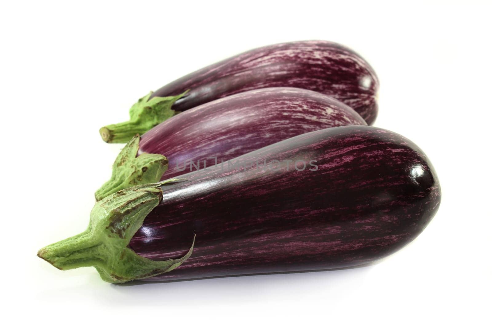 three eggplants against a white background