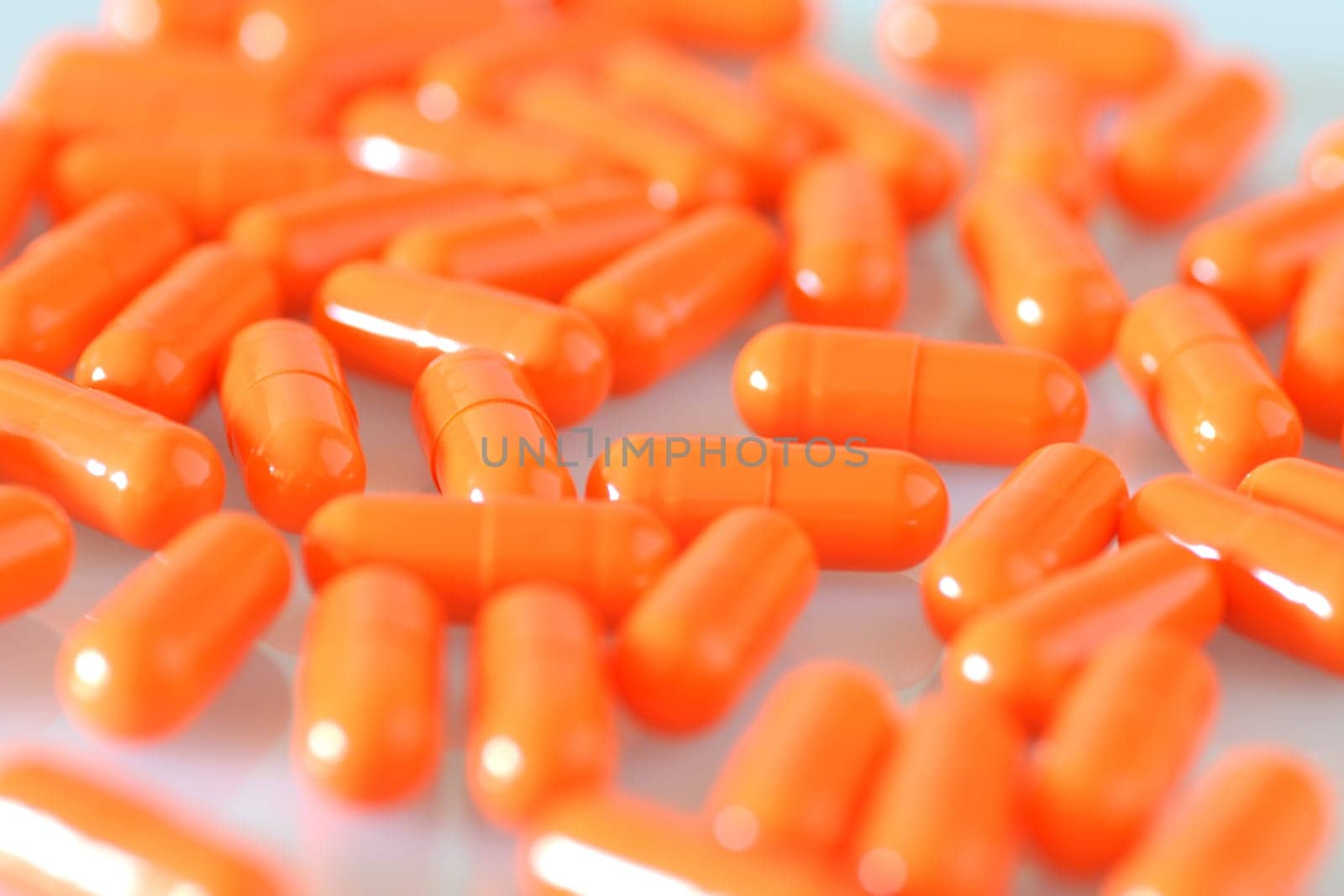 close up on planty orange capsules. many capsules with the antibiotics.