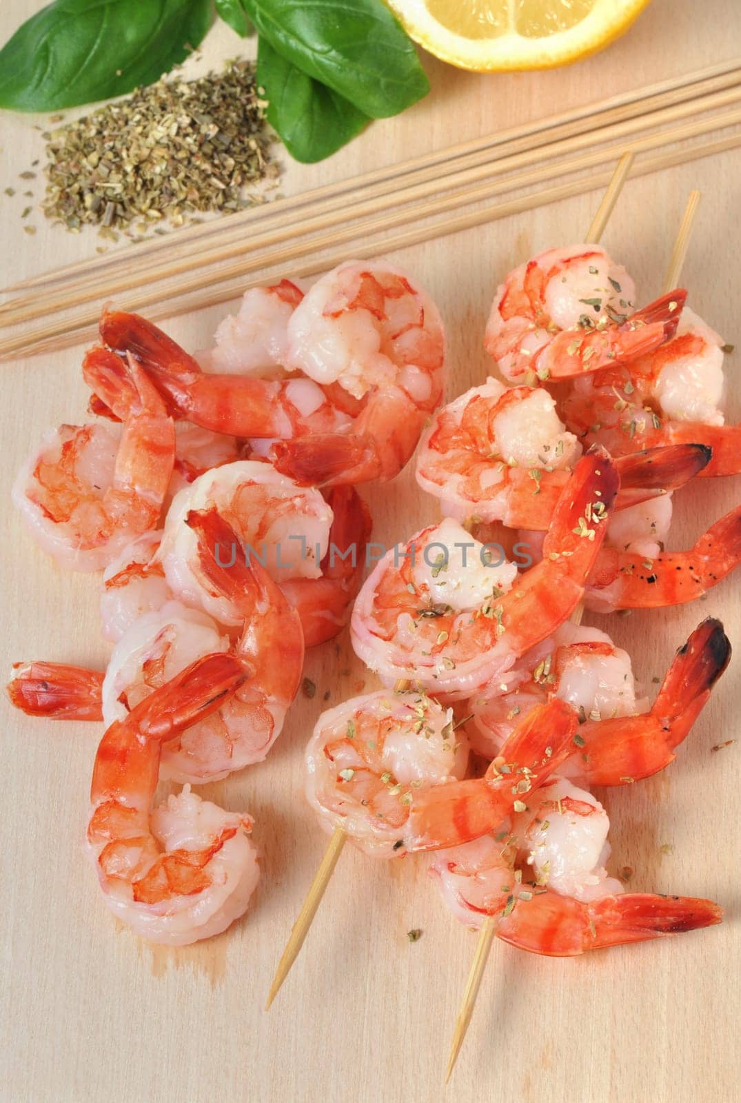 shrimps,lemon and basil on board isolated on white background