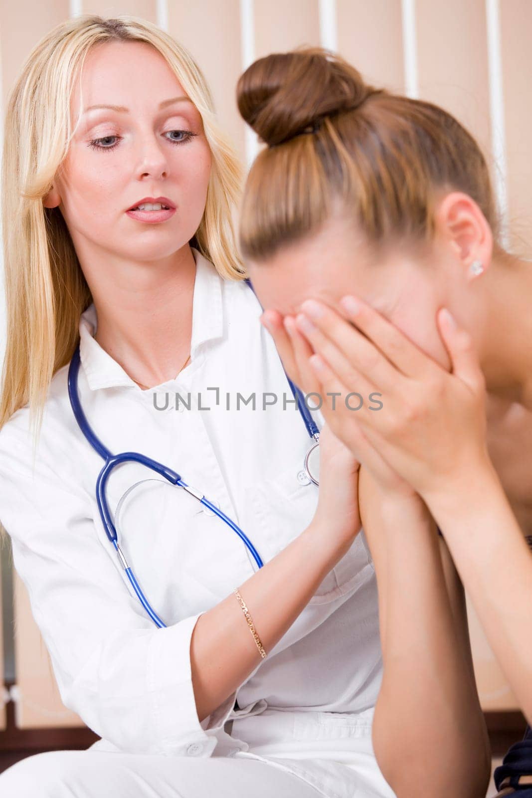 woman doctor and crying patient in her office
