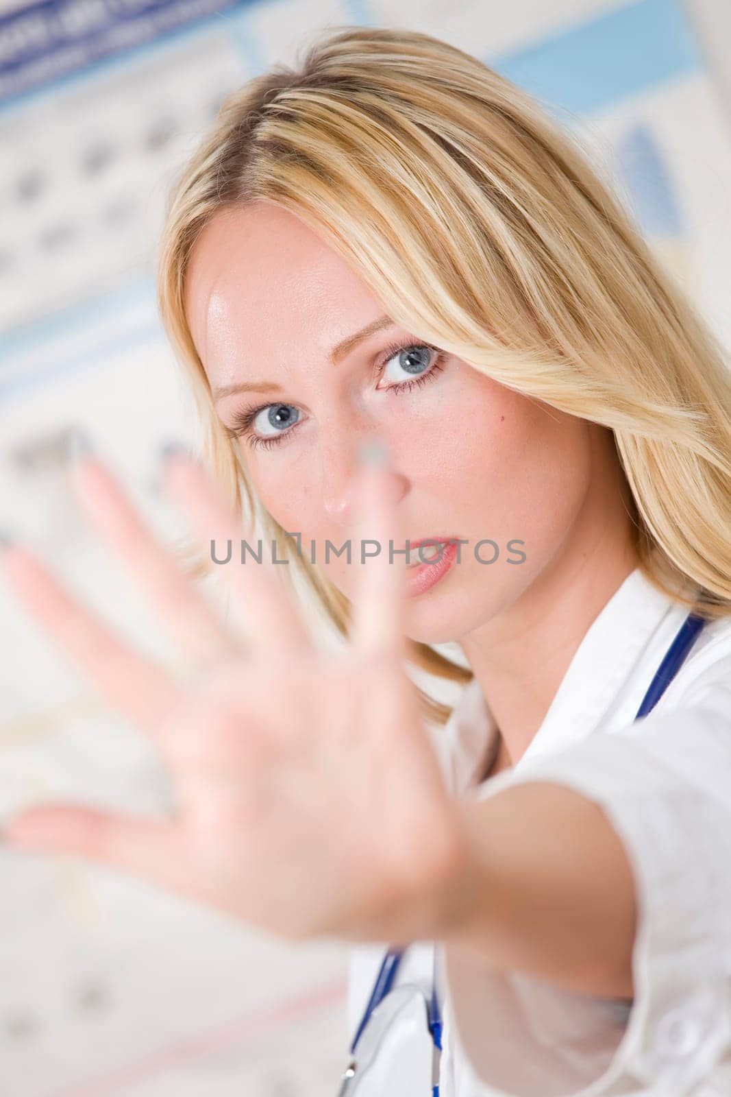 young woman doctor showing stop gesture