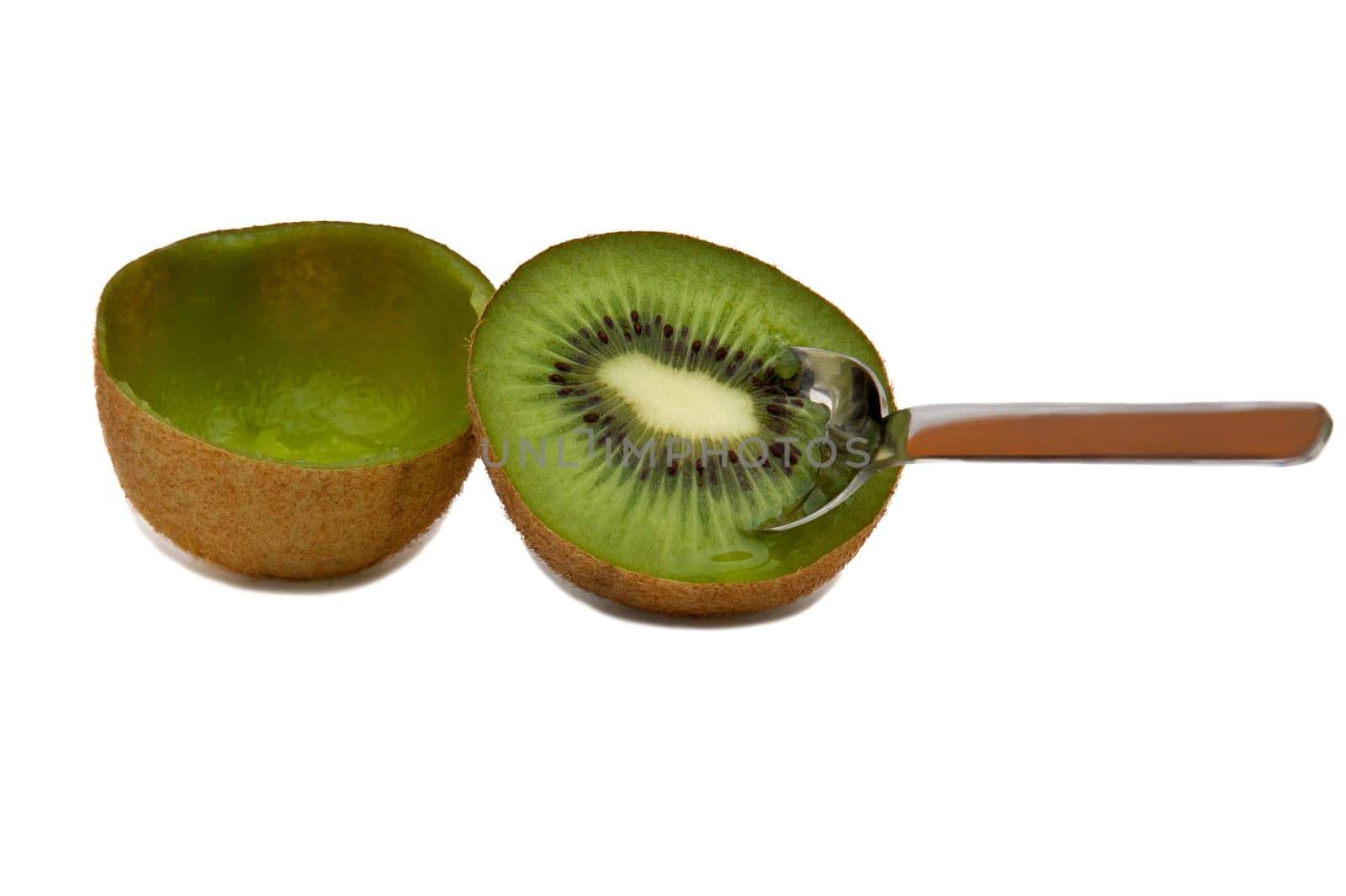 A sliced empty kiwi and a half with a spoon inserted into it