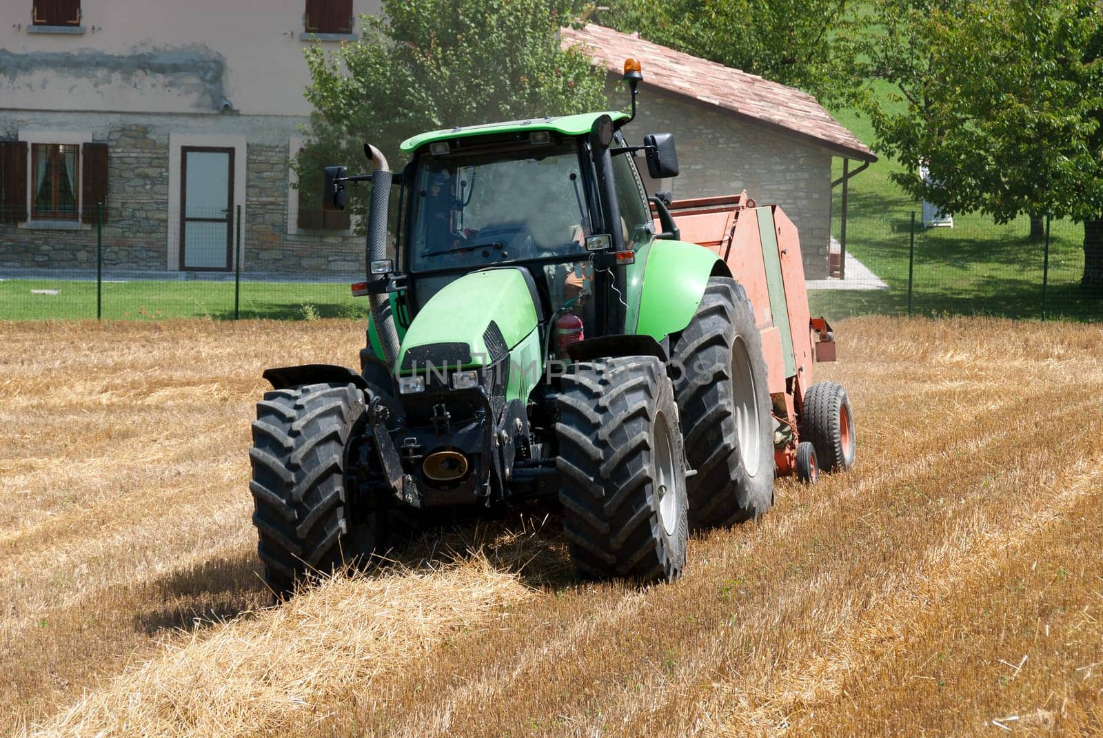 tractor in a field of freshly cut wheat