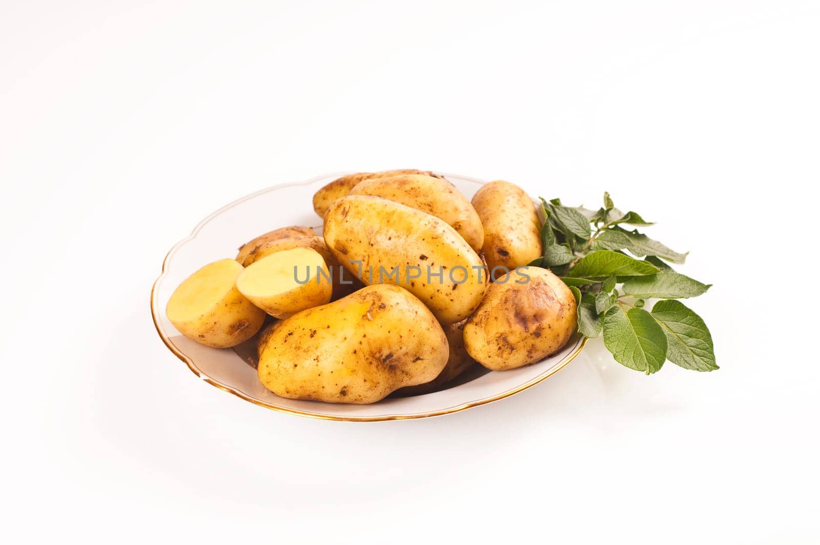 fresh potatoes on porcelain plate