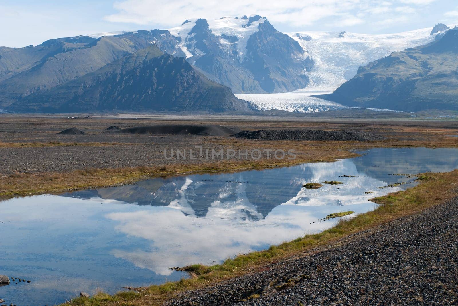 Vatnajökull glacier reflected in a river