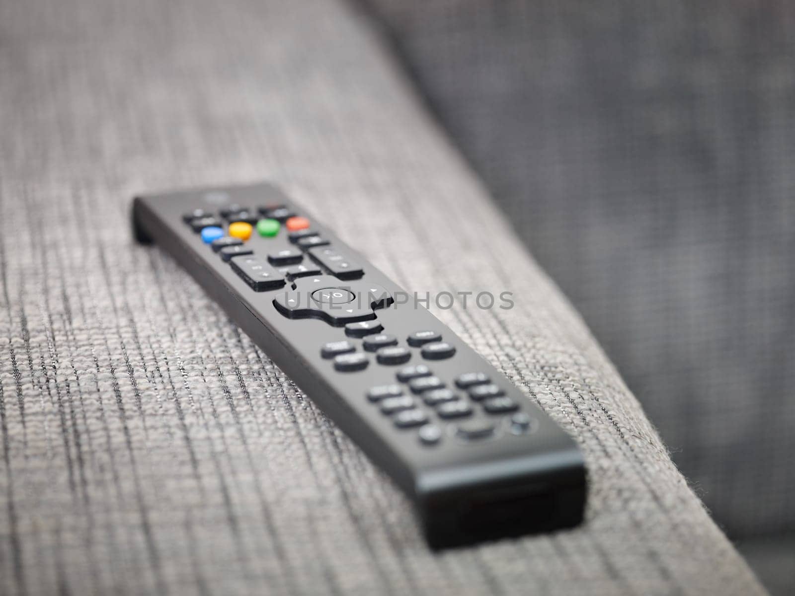 closeup of television remote control on sofa. Horizontal shape, copy space