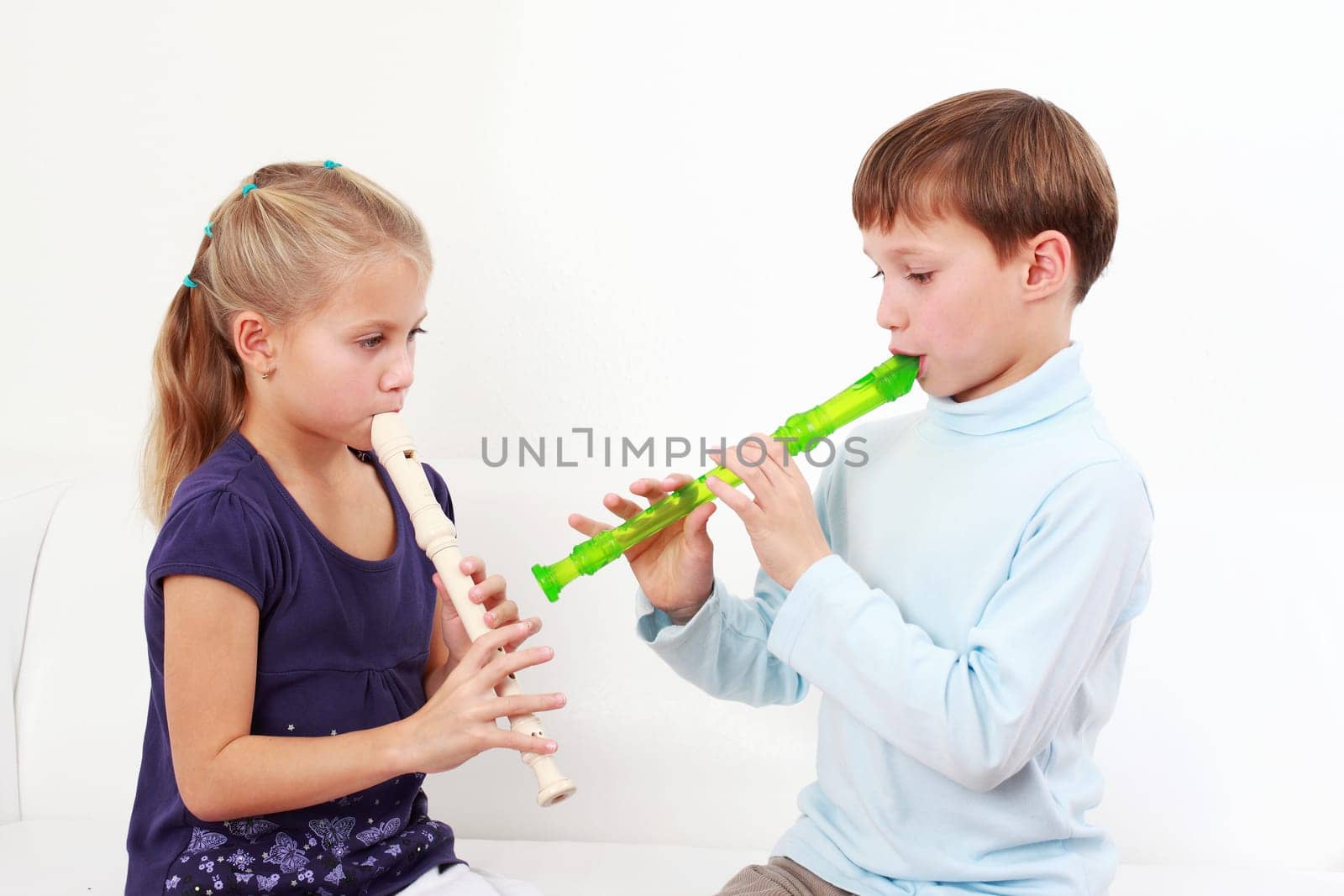 Cute kids playing flute together