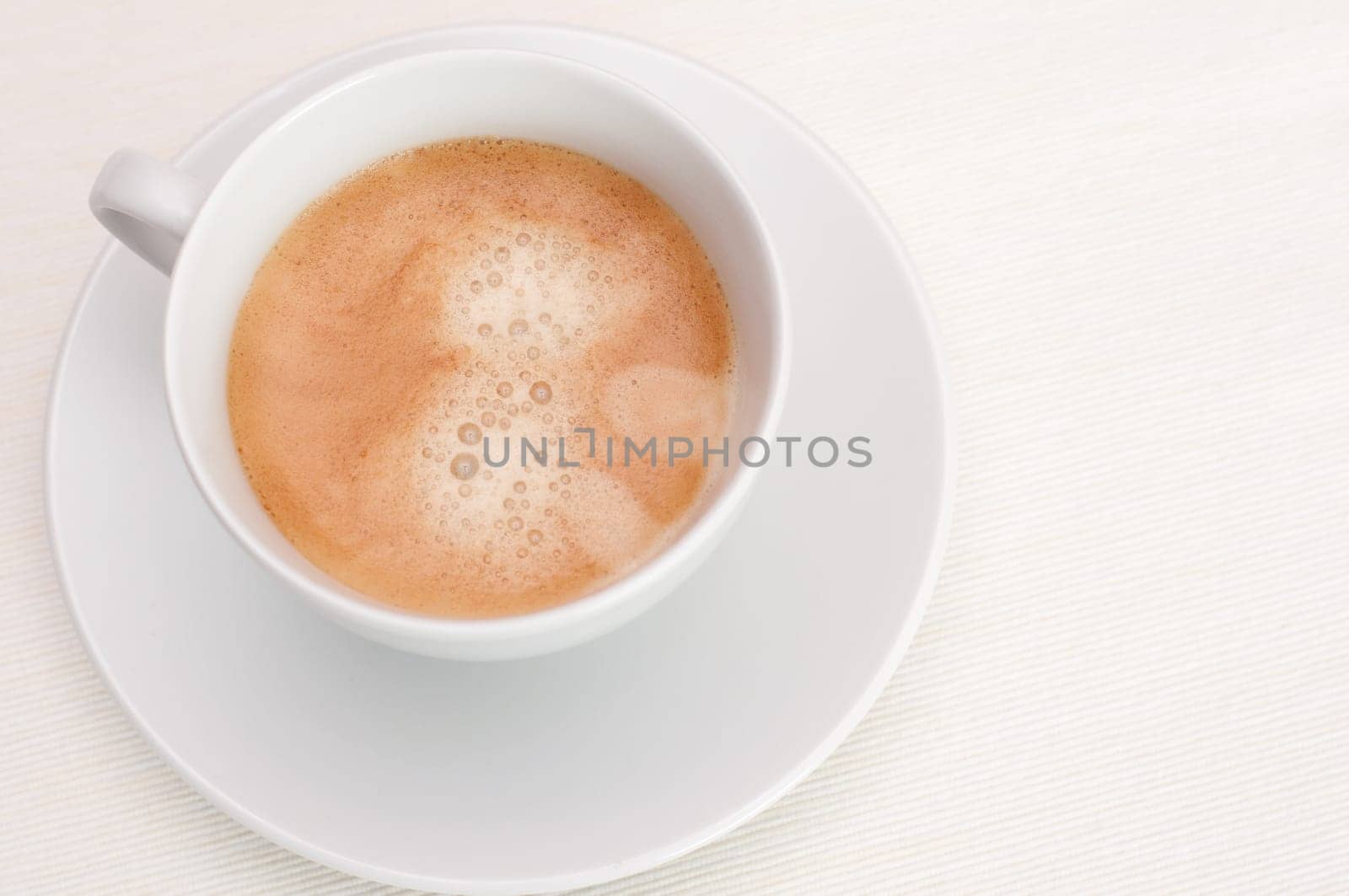 Espresso Coffee in White Cup on Light Tablecloth