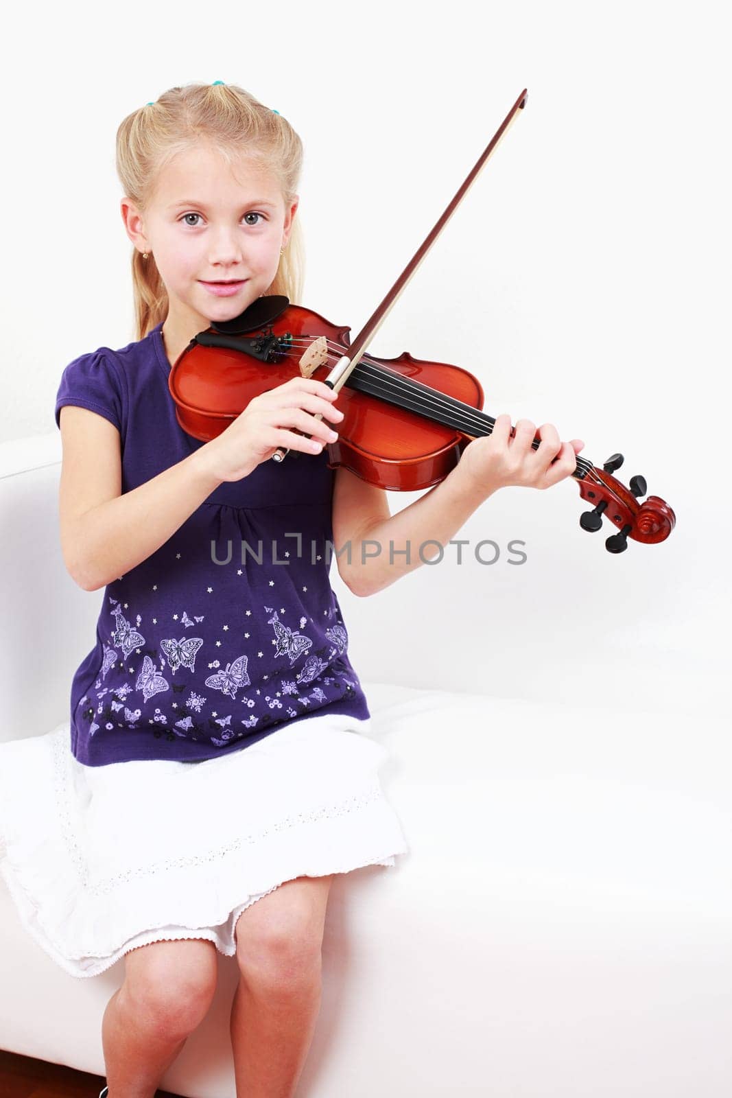 Cute little girl playing violin