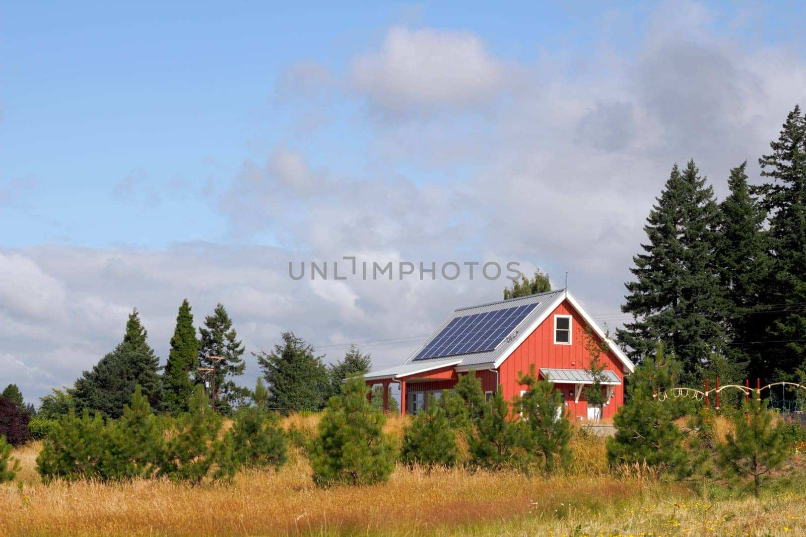 Solar panels on the roof of a public building in a park.