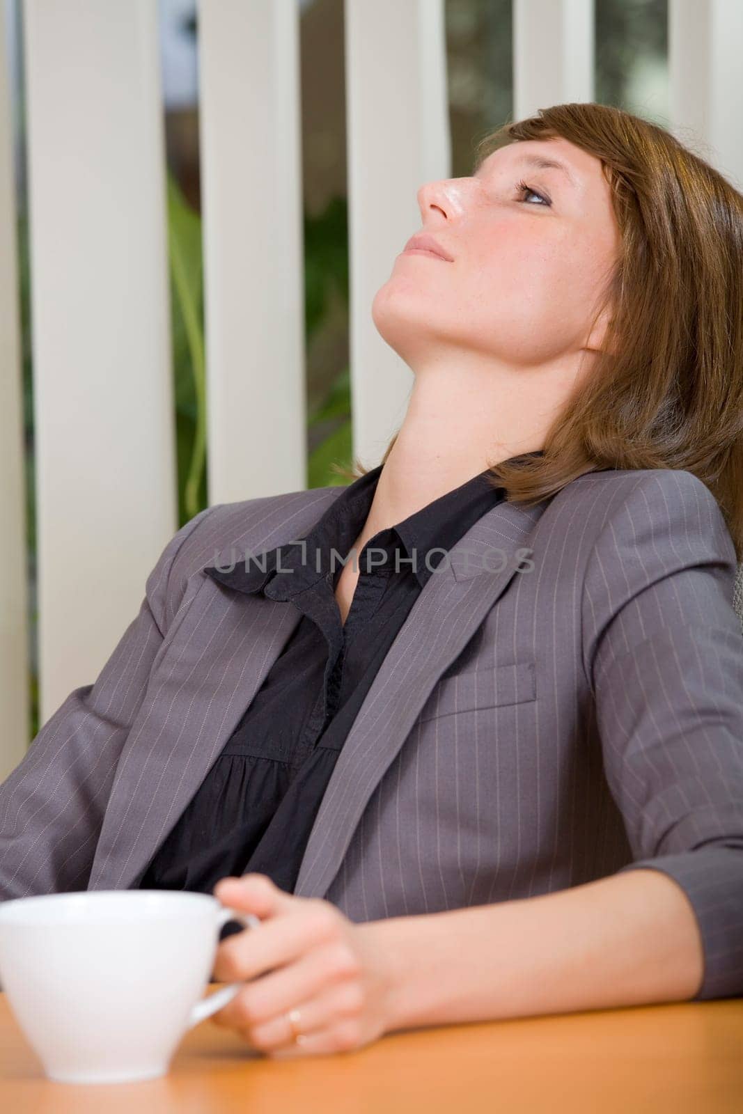 coffee break in office - relaxing woman with cup tea