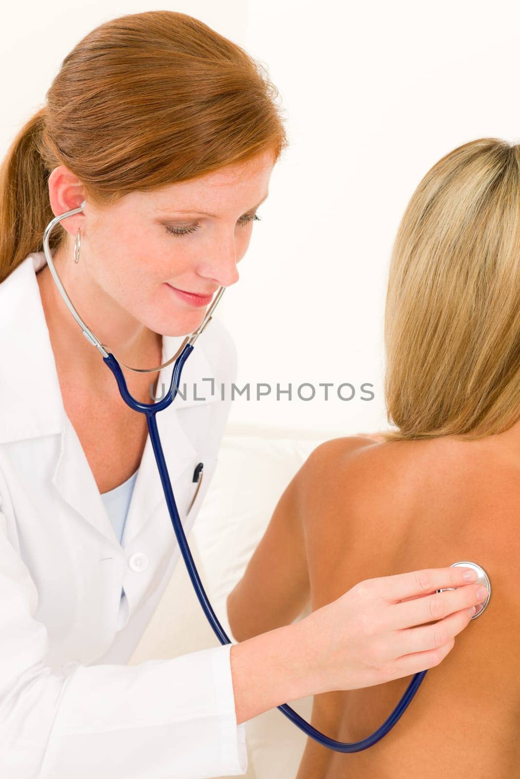 Medical professional doctor with stethoscope examine woman patient naked back