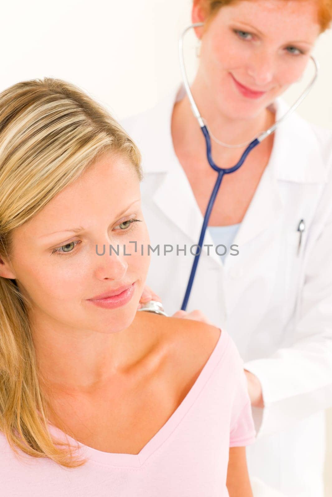 Medical professional doctor with stethoscope examine woman patient back