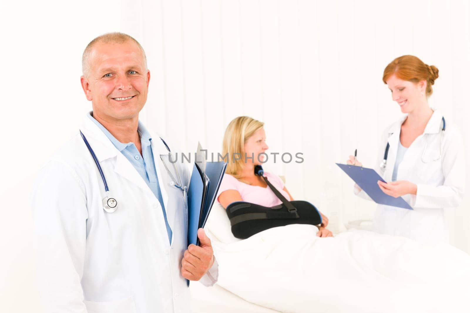 Two medical doctors professional with hospital patient lying in bed