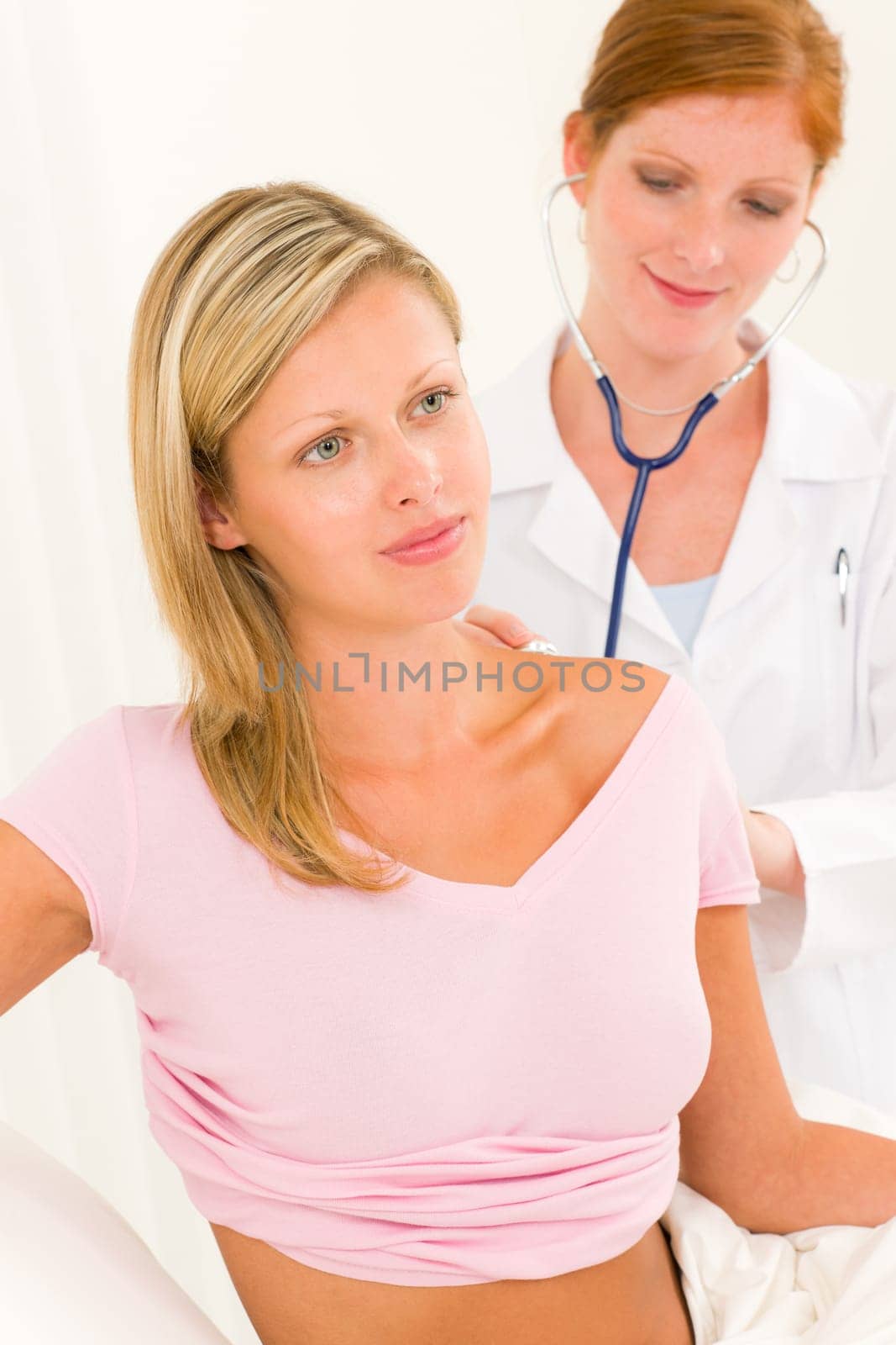 Medical professional female doctor with stethoscope examine woman patient back