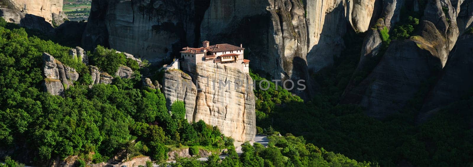 Panorama of Monastery of Rousanou in famous greek tourist destination Meteora in Greece on sunset with scenic landscape.