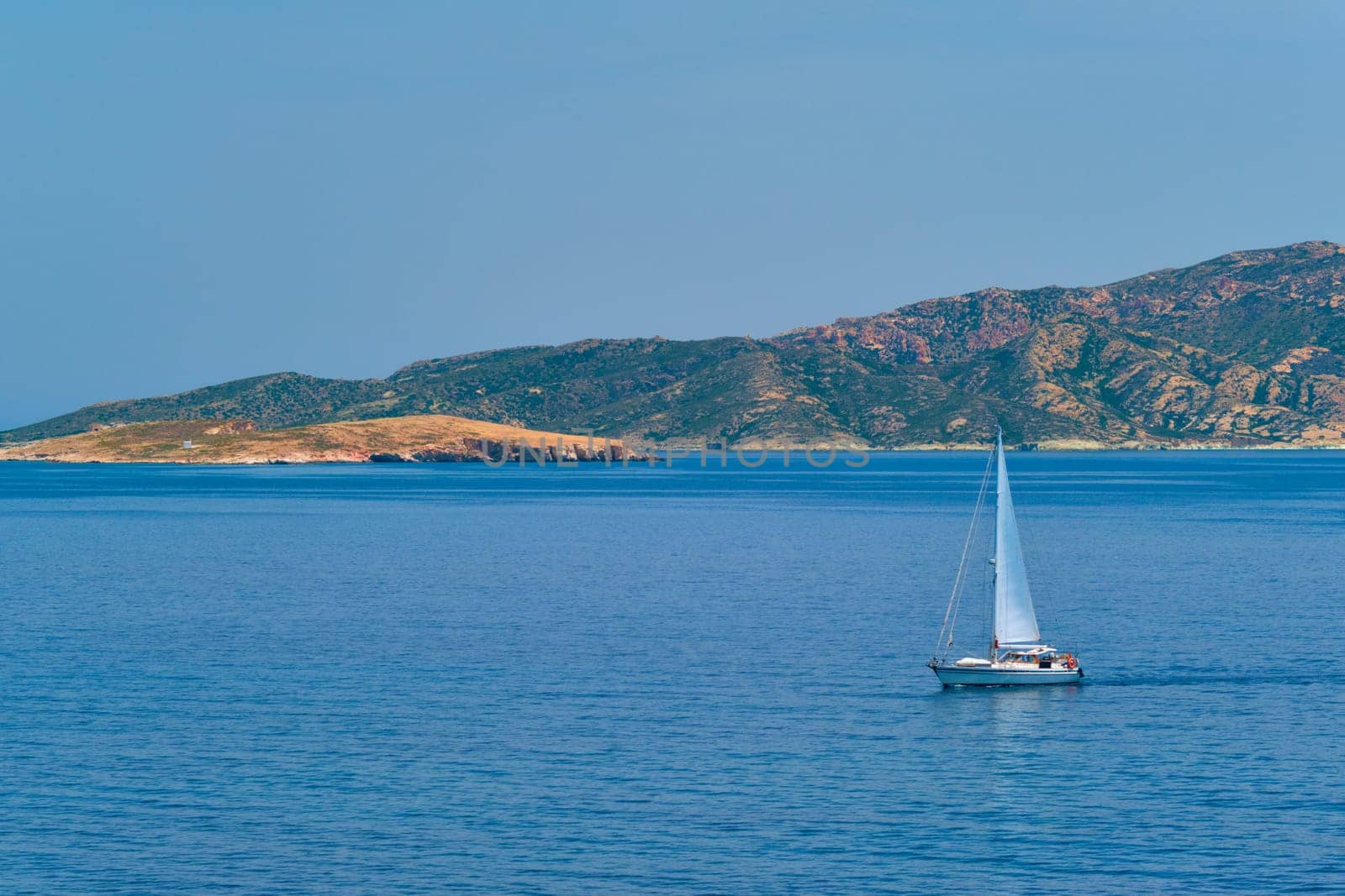 Yacht boat in blue waters of Aegean sea near Milos island , Greece