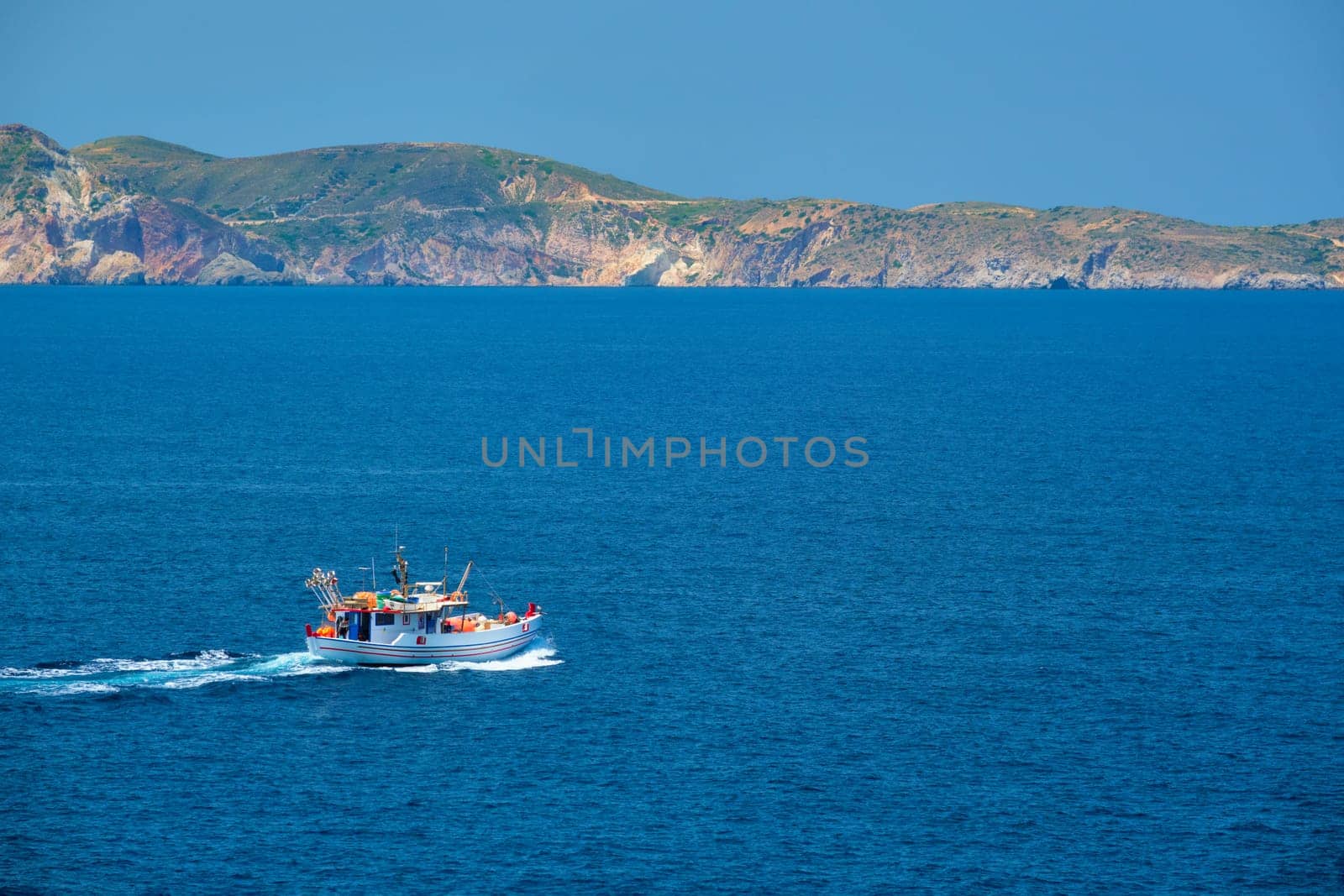 Greek fishing boat in Aegean sea near Milos island, Greece by dimol
