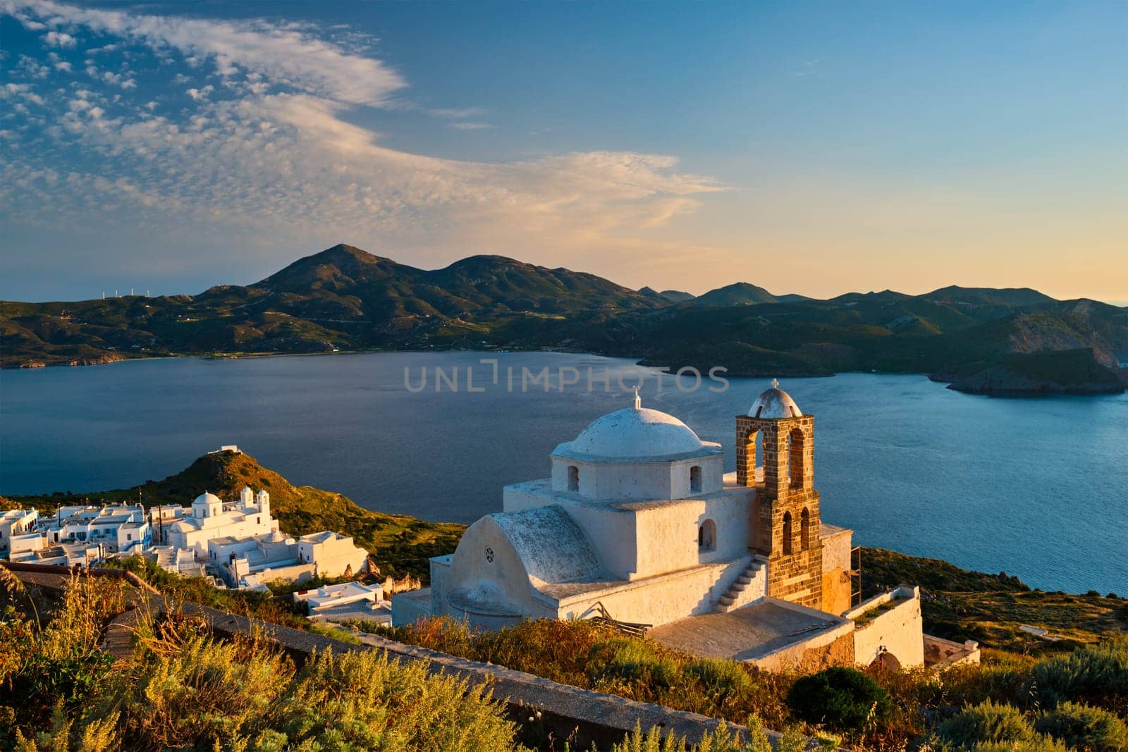 Traditional whitewashed Greek Orthodox church in Plaka village on Milos island on sunset. Milos island, Greece