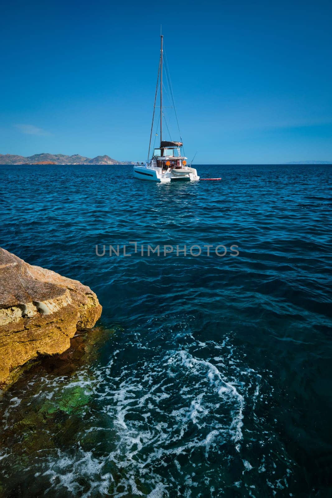 Yacht boat in Aegean sea at white rocks of Sarakiniko Beach, Milos island , Greece