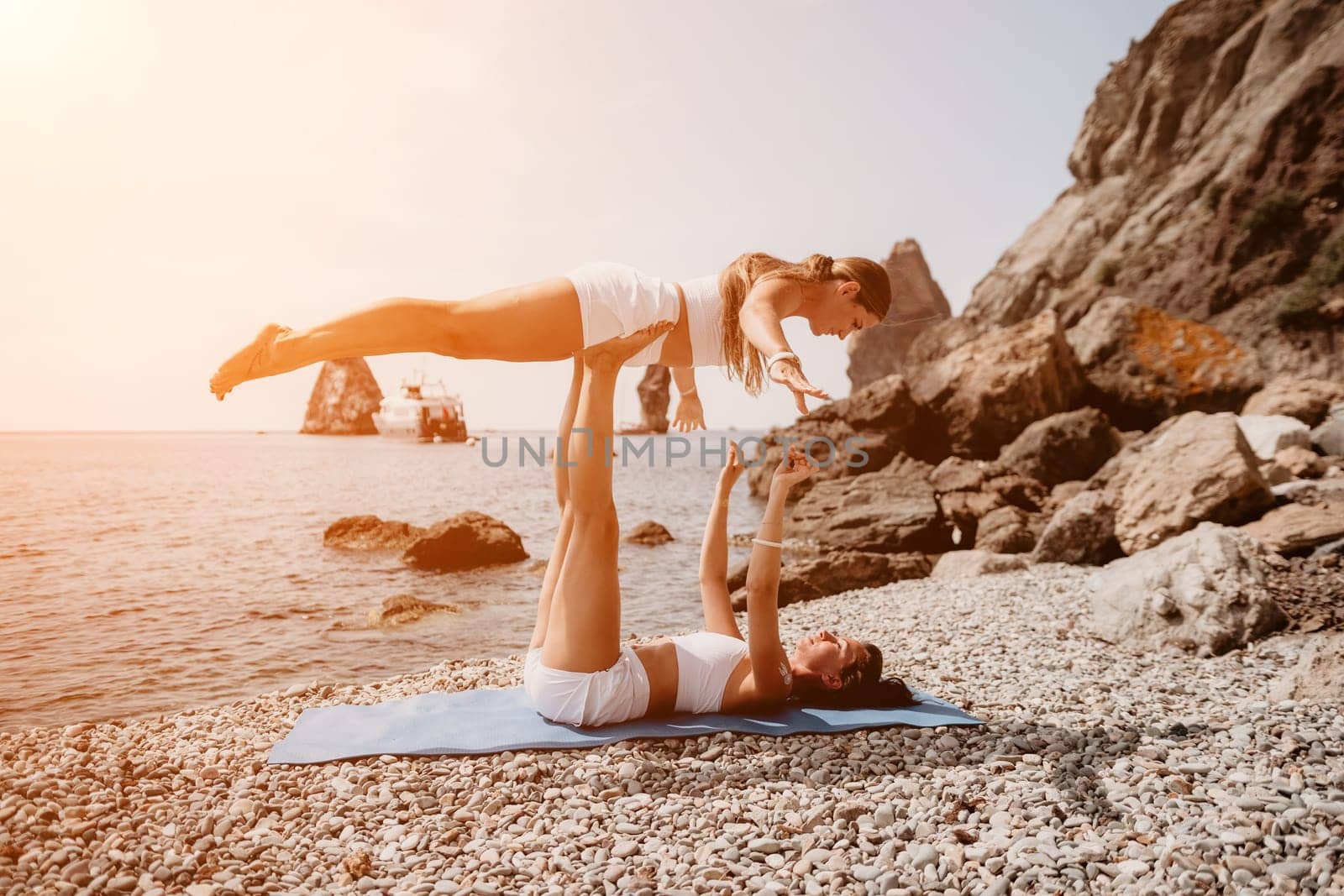 Woman sea yoga. Back view of free calm happy satisfied woman with long hair standing on top rock with yoga position against of sky by the sea. Healthy lifestyle outdoors in nature, fitness concept.