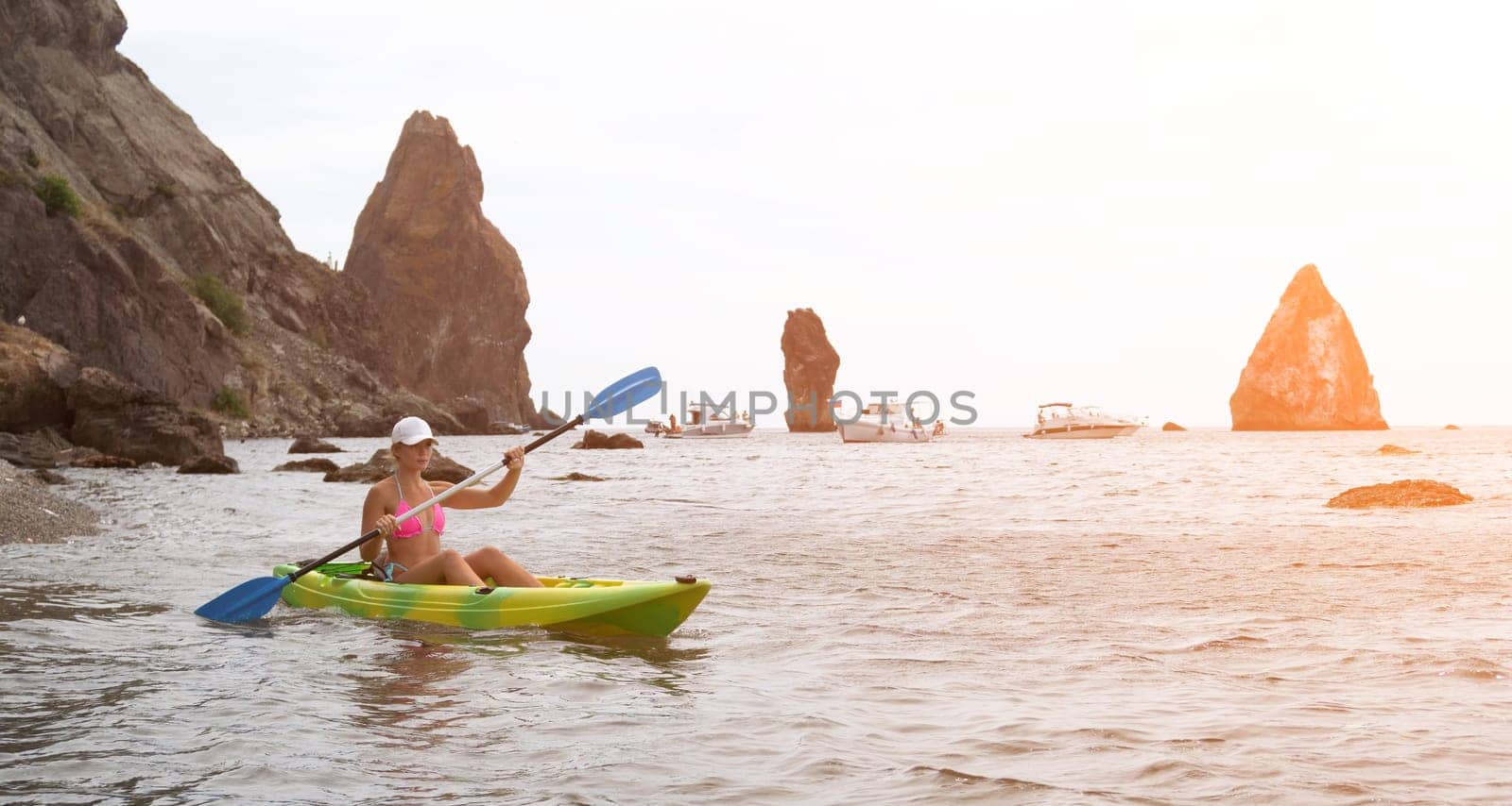 Kayaking. Travel adventure kayak on the tropical sea on a sunny day. Woman rowing a canoe.