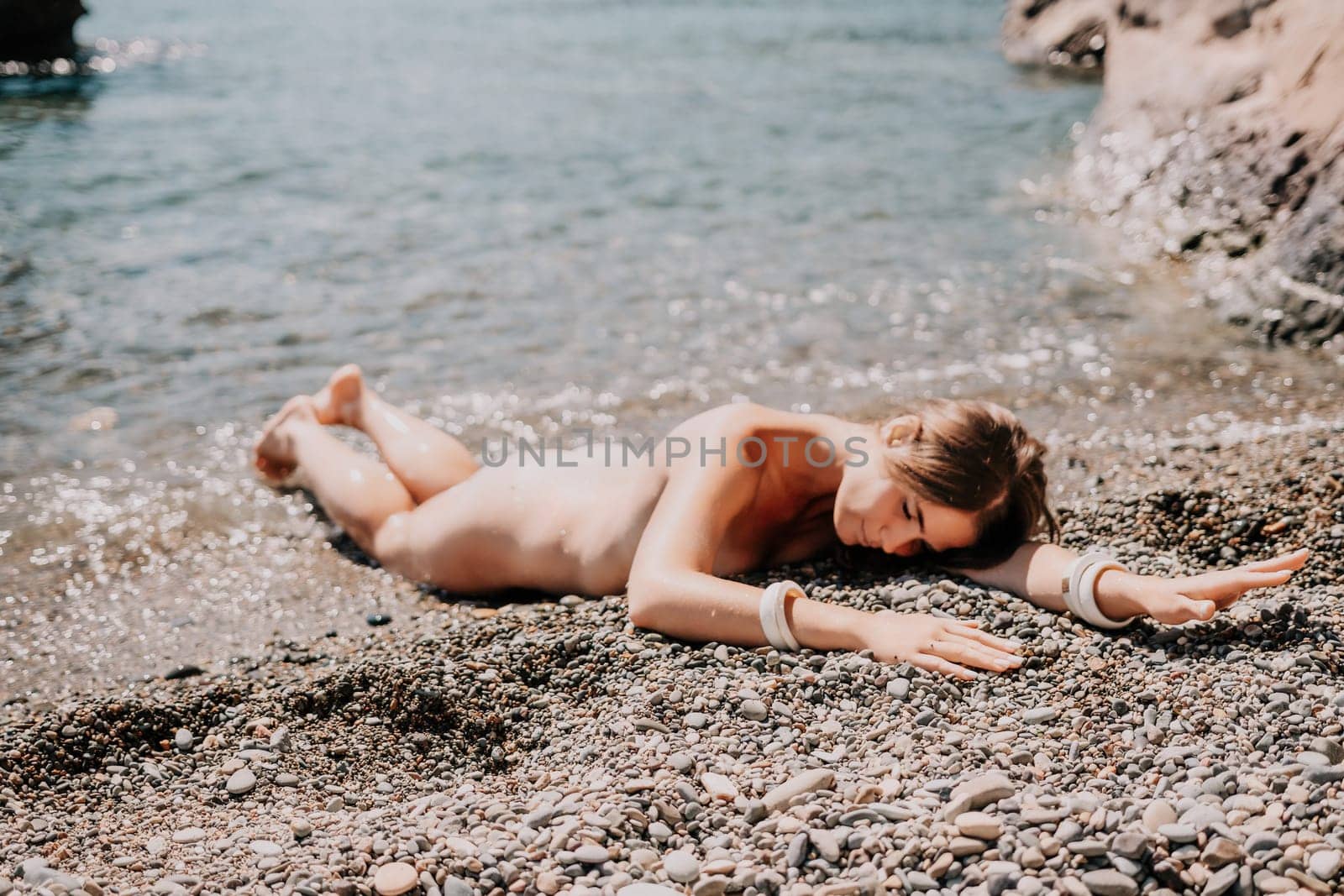 Woman travel sea. Happy tourist in hat enjoy taking picture outdoors for memories. Woman traveler posing on the beach at sea surrounded by volcanic mountains, sharing travel adventure journey by panophotograph