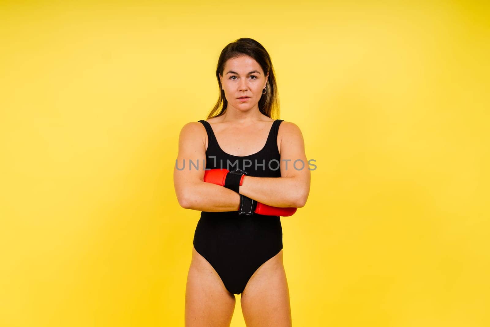 Young woman athletic female MMA fighter is training. Concept of sport, action, healthy lifestyle.