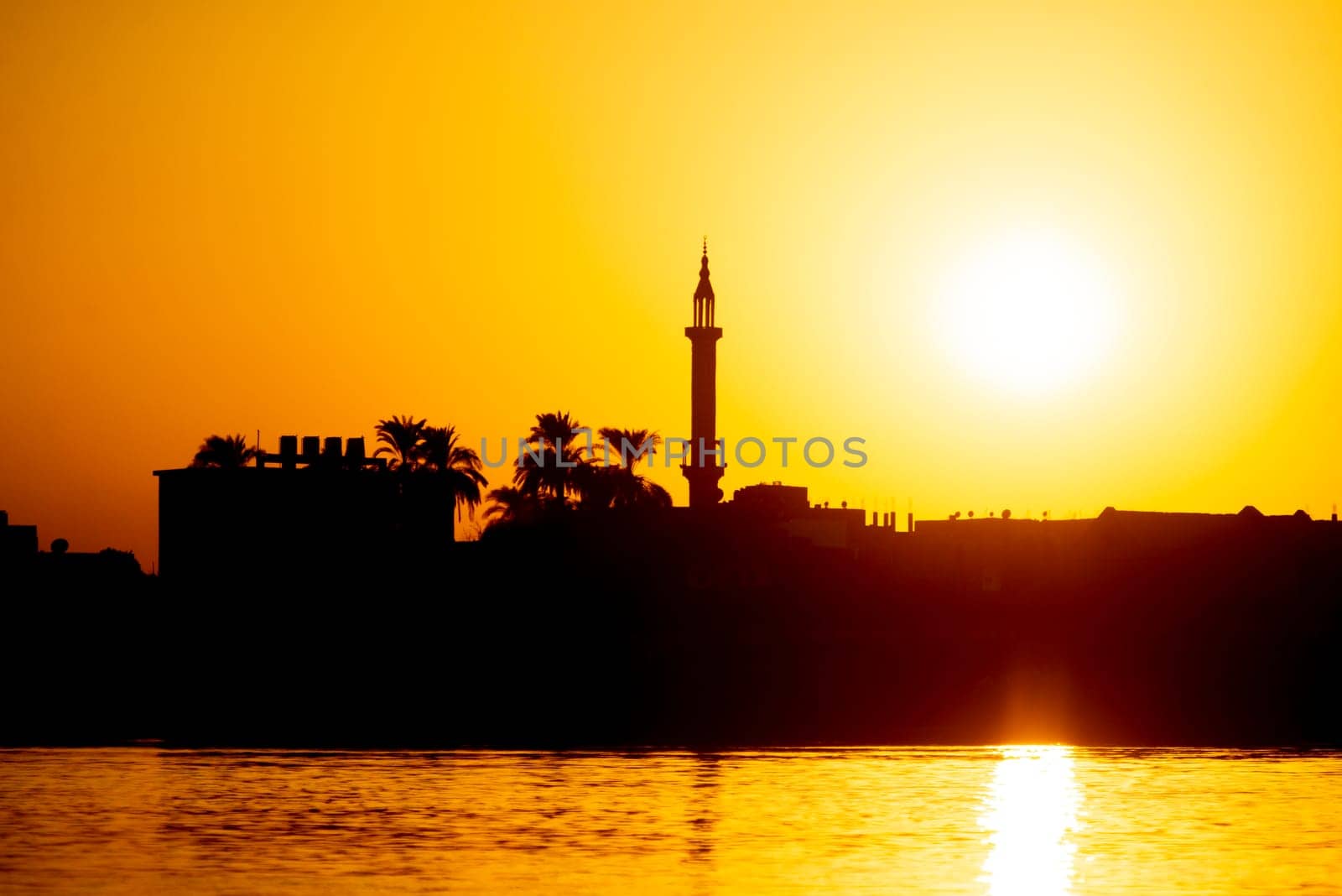 Landscape view of large river at sunset with minaret by paulvinten