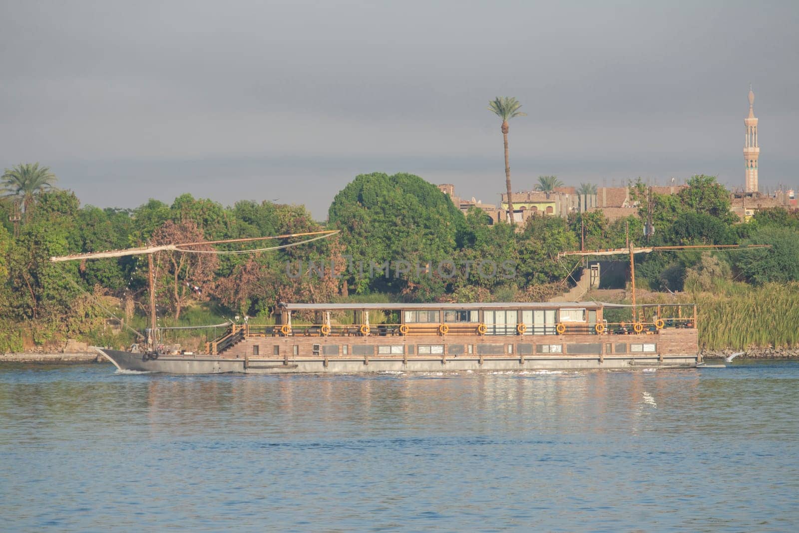 Large luxury traditional Egyptian dahabeya river cruise boat sailing on the Nile