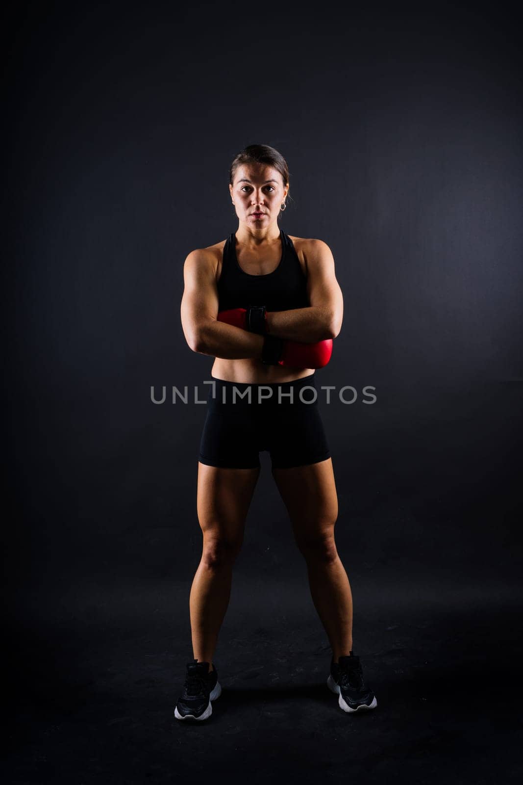 Young woman athletic female MMA fighter training. Concept of sport, action, healthy lifestyle. by Zelenin