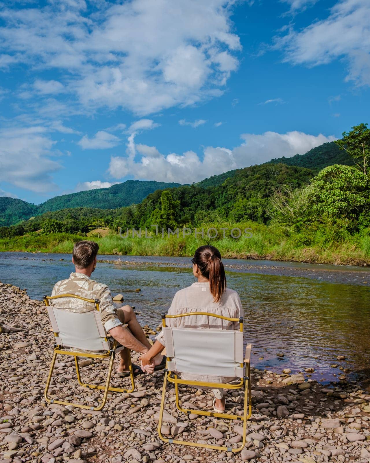 a couple of men and woman camping at the river in Nan Sapan Thailand, men and woman relaxing in the mountains of Northern Thailand