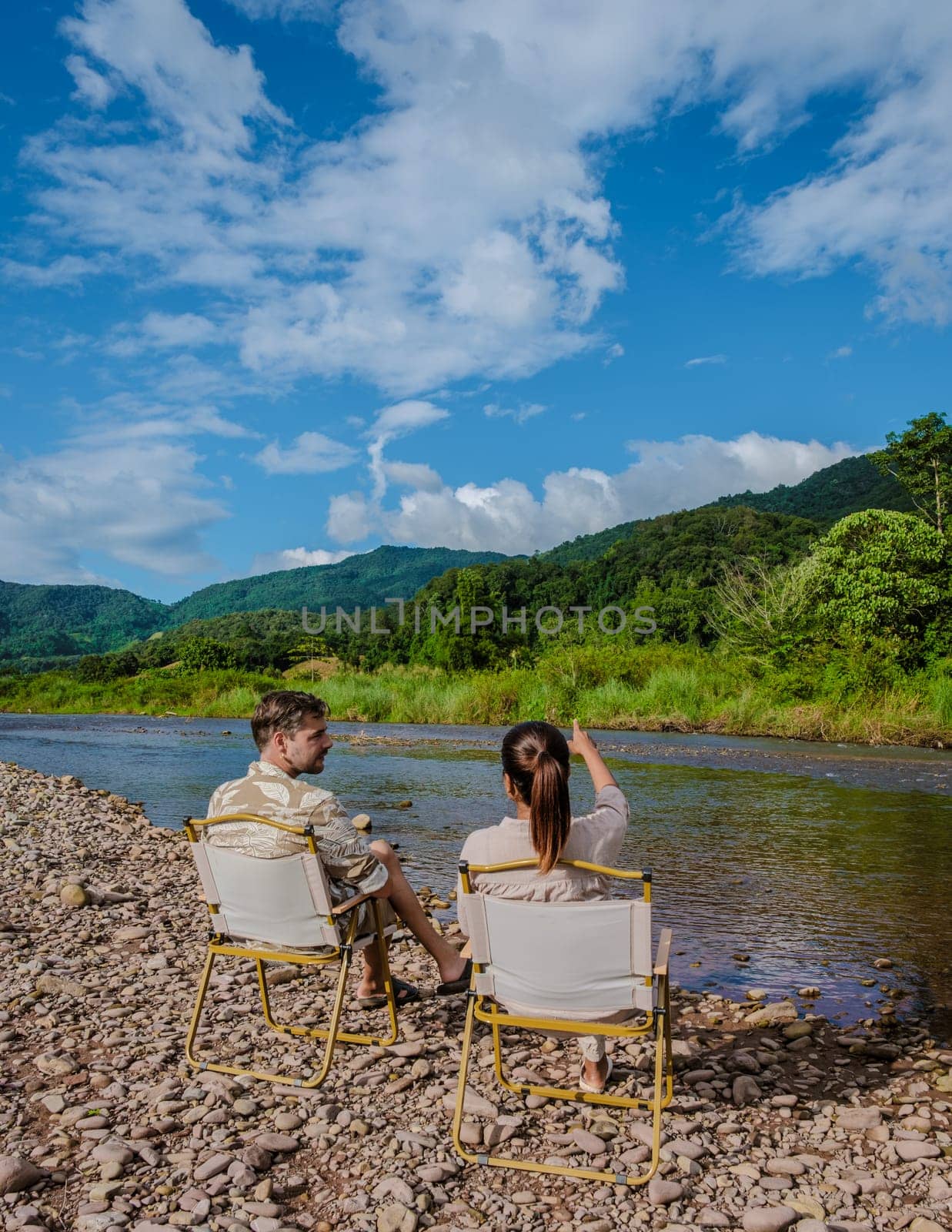 a couple of men and woman camping at the river in Nan Sapan Thailand, men and woman relaxing in the mountains of Northern Thailand