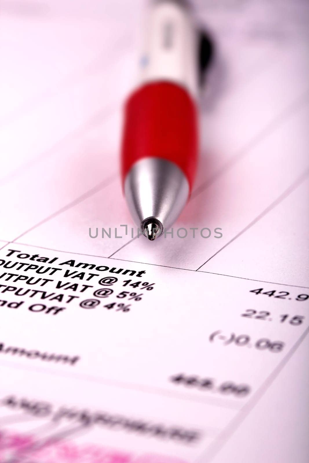 A ball point pen and bill close up