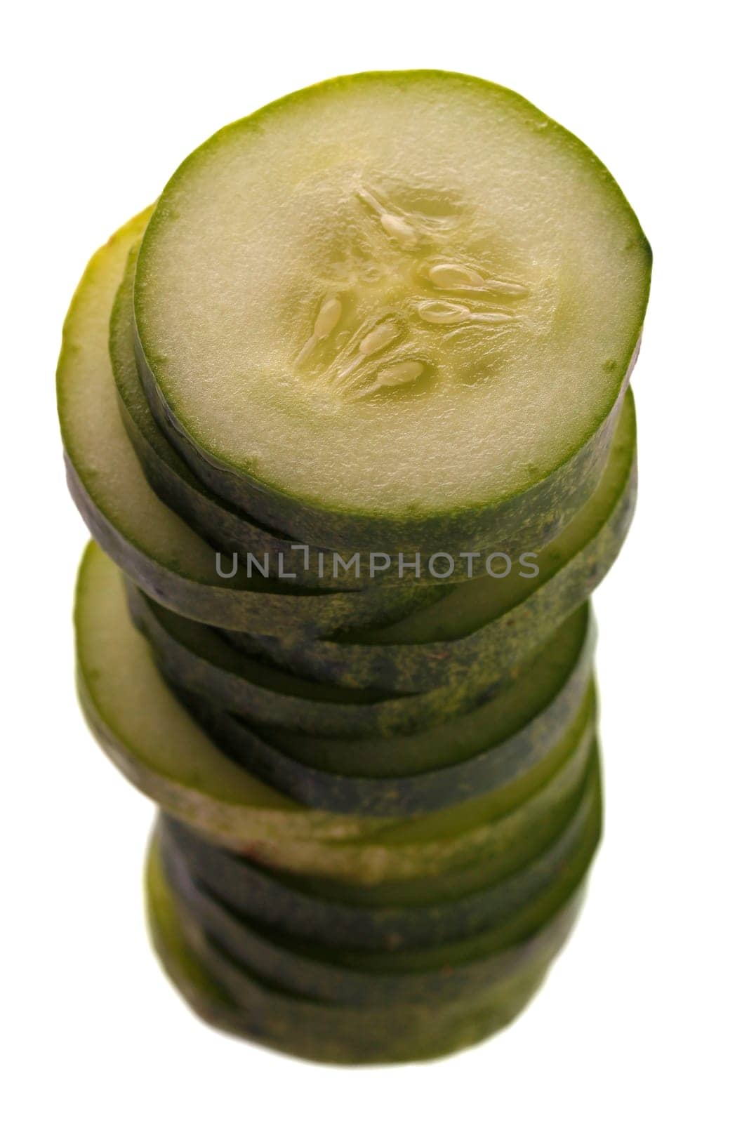 cucumber slices piled one above the other isolated on white