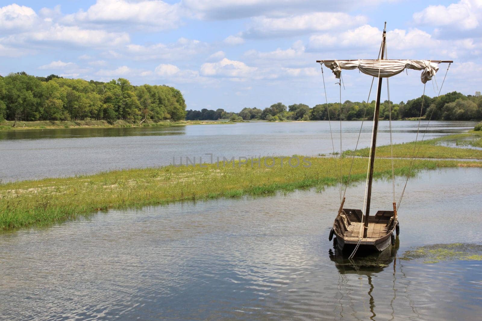 boat or boat anchored on a river against a backdrop of wilderness
