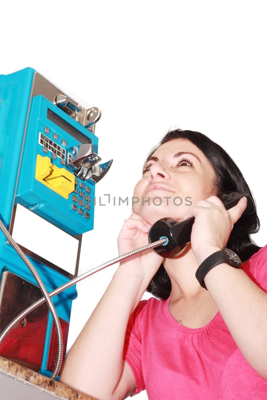 Beautiful woman happy talking on the public phone