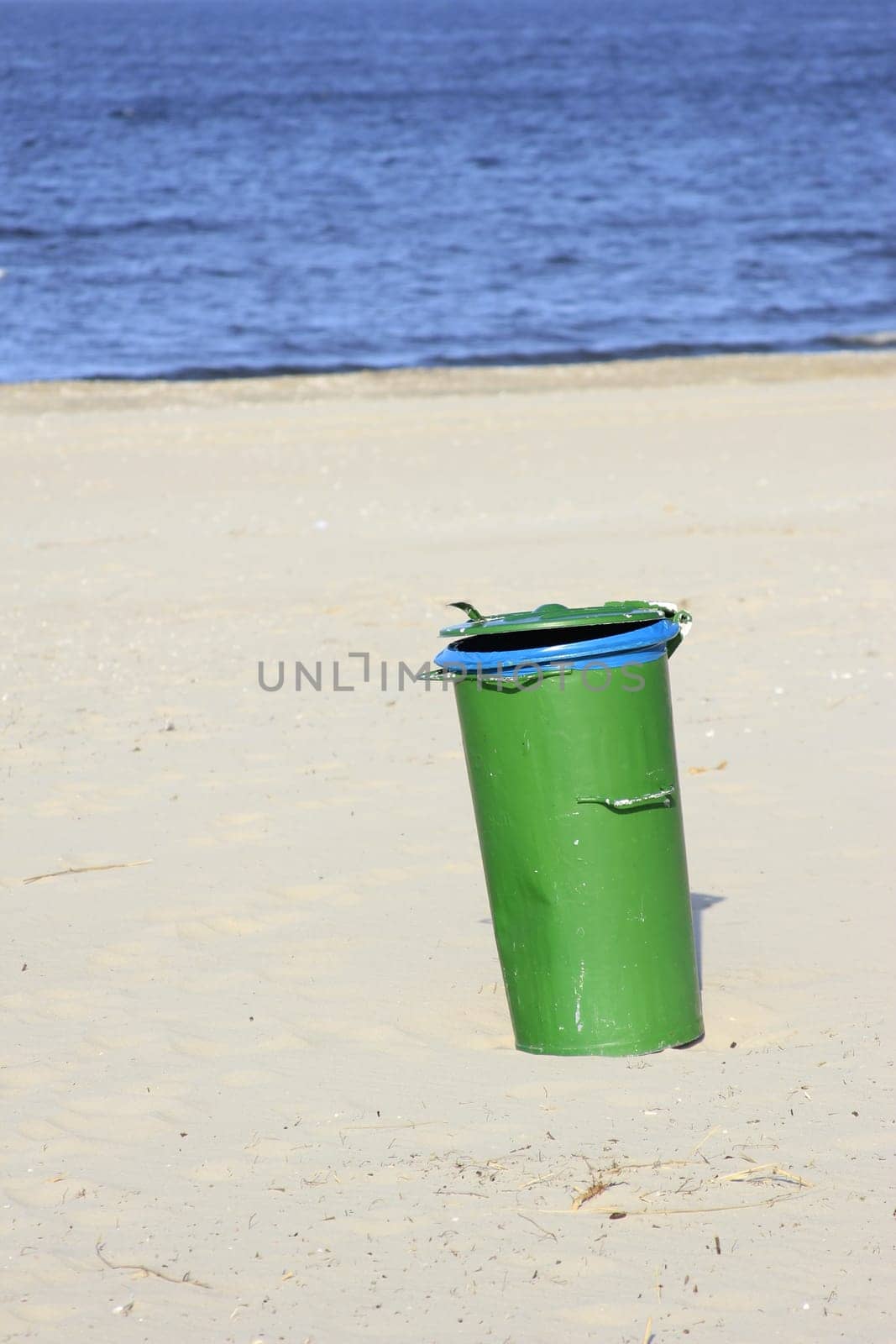 green garbage can on the beach of the island of Usedom,Mecklenburg-Western Pomerania,Germany