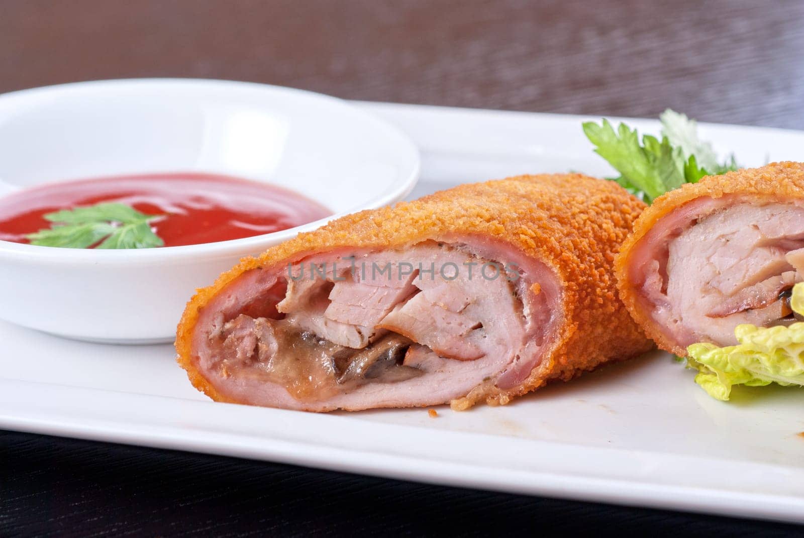 Closeup of rolls from pork meat, champignon mushroom, cheese and sauce