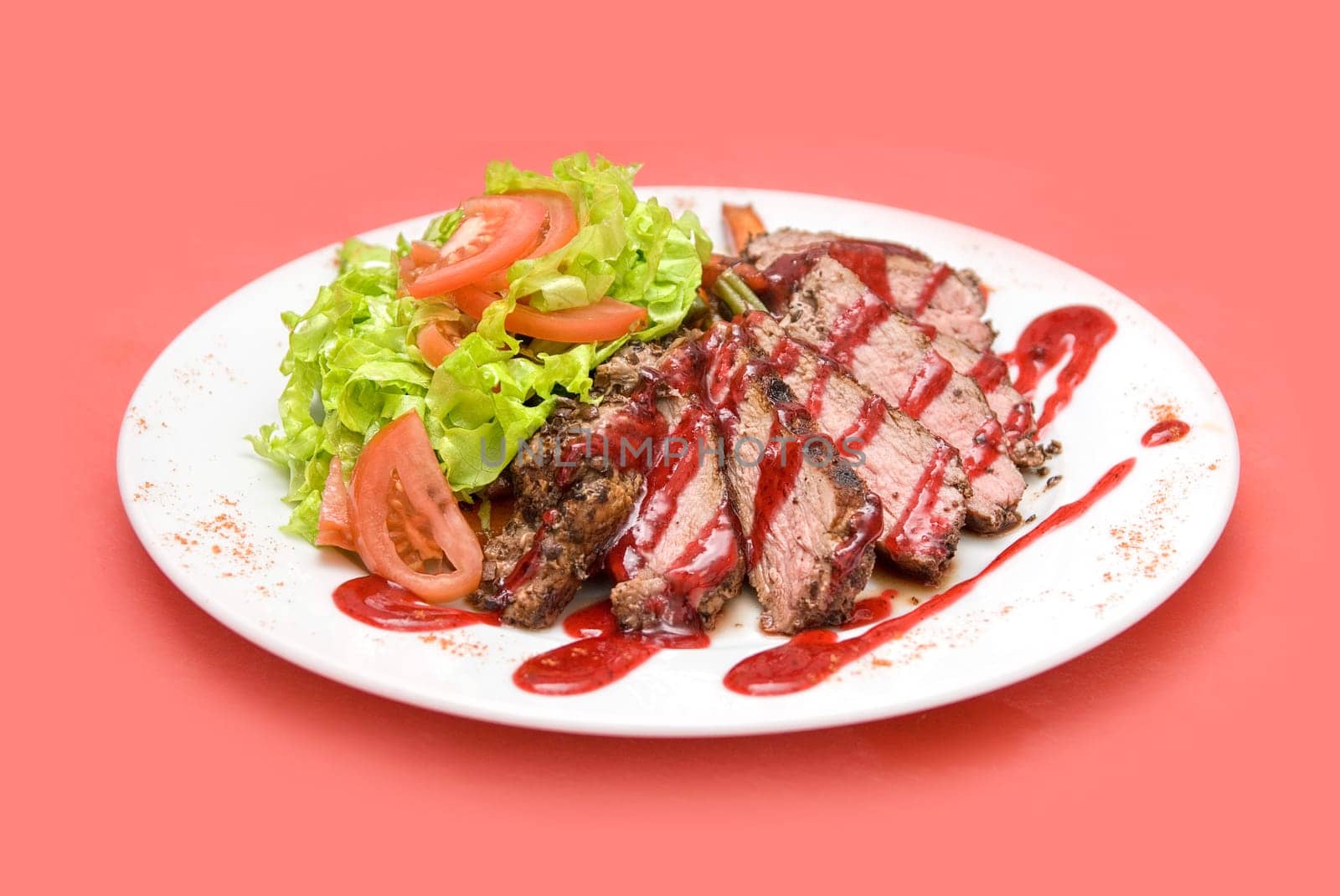 Roasted Beef meat at cranberries sauce with vegetables